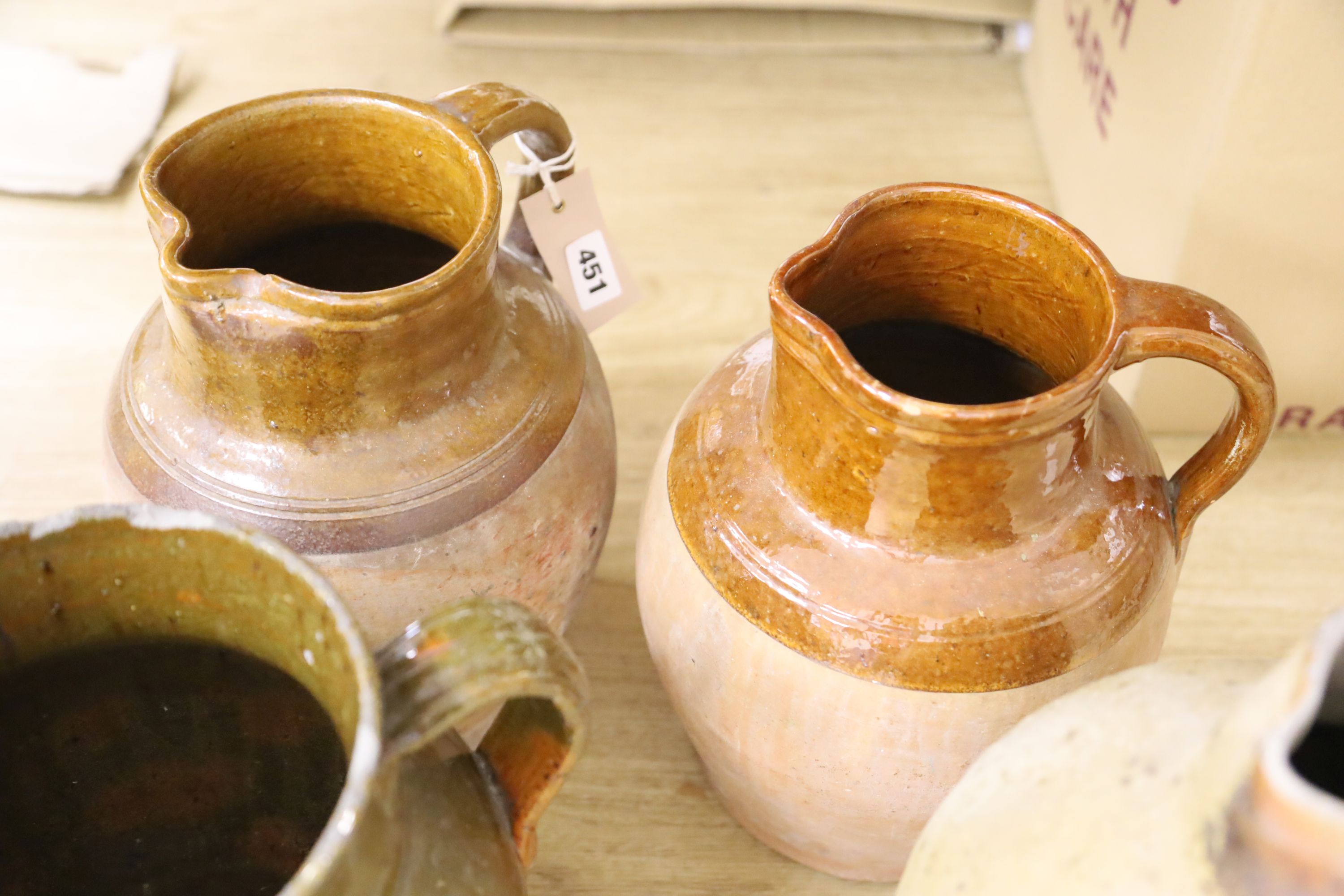 Four Sussex pottery jugs, tallest 34cm